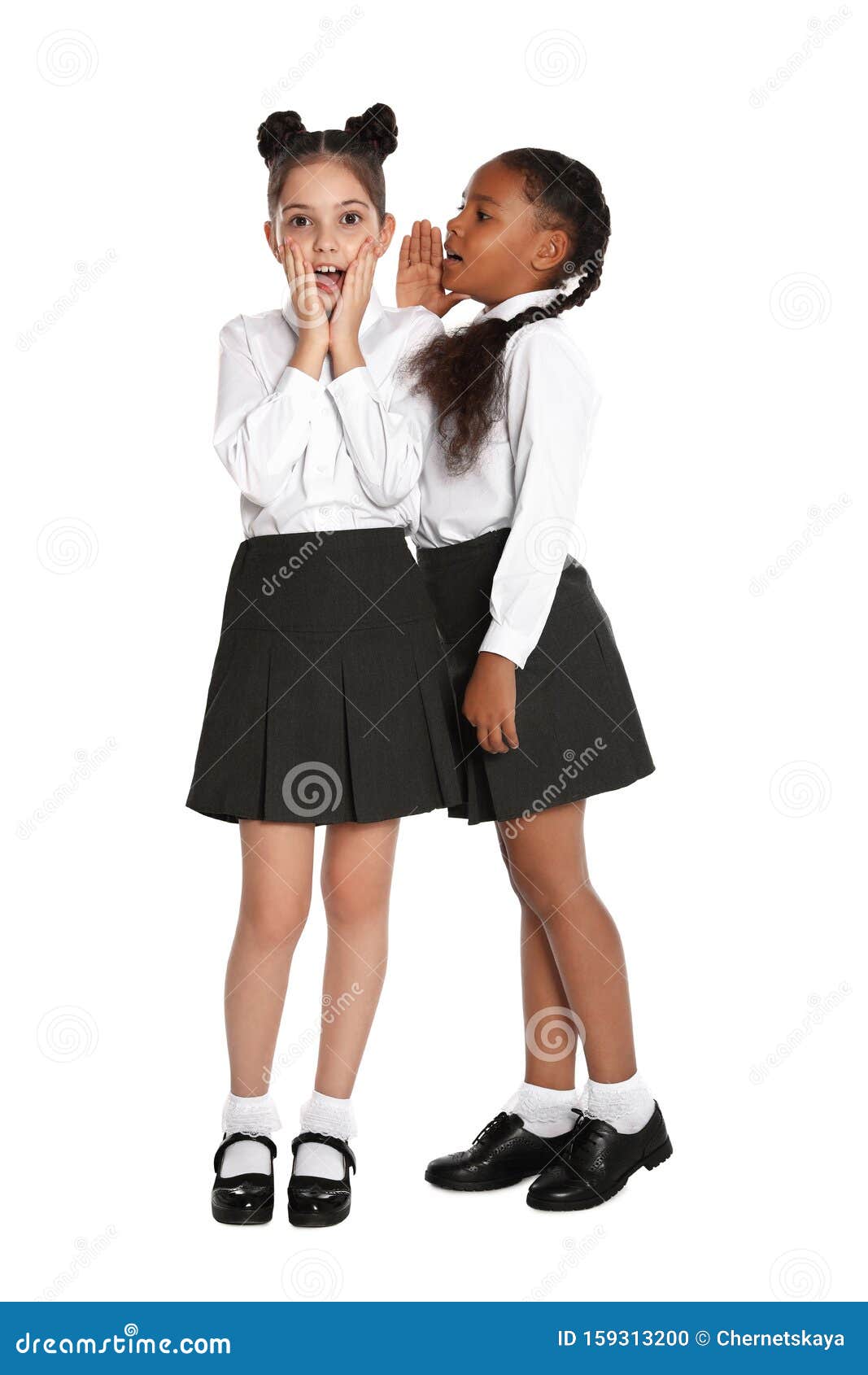 1067x1690  Девочки в школьной форме сплетни на фоне стоковая фото - изображение моды, люди: 159313200