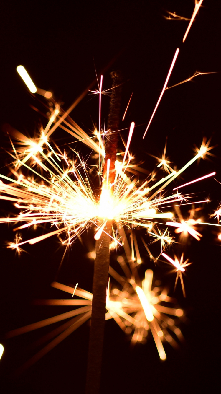 750x1334  hd Wallpaper: Человек, держащий огненные работы, Sparkler, Firework, Bokehhess
